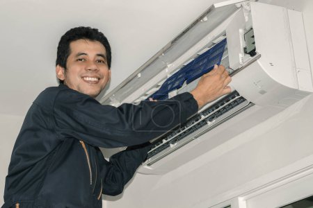 Photo for Air con mechanic man at home - Royalty Free Image