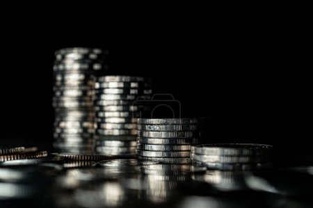Stack of silver coins on dark background