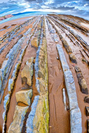 Photo for Steeply-tilted Layers of Flysch, Basque Coast UNESCO Global Geopark, Spain - Royalty Free Image