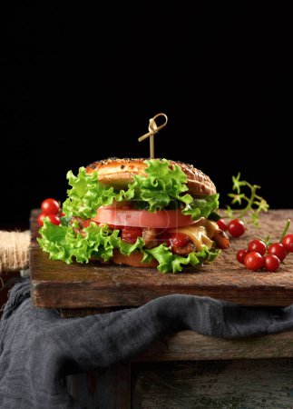 Photo for Cheeseburger with minced meat, green lettuce and ketchup - Royalty Free Image