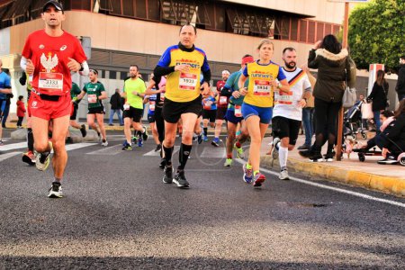 Photo for Santa Pola, Spain- January 20, 2019: Runners in the Half Marathon of the fishing village of Santa Pola, province of Alicante, on a sunny day in January - Royalty Free Image