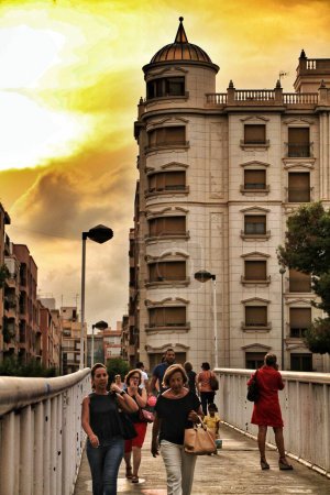 Photo for People crossing a bridge at sunset in Elche - Royalty Free Image