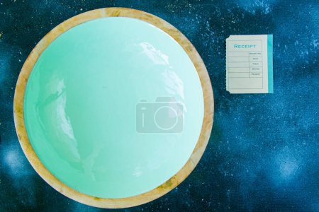 Photo for Bowl on the blue background and old paper with receipt - Royalty Free Image