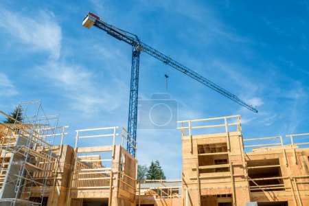 Photo for Crane above the new low-rise building under construction - Royalty Free Image