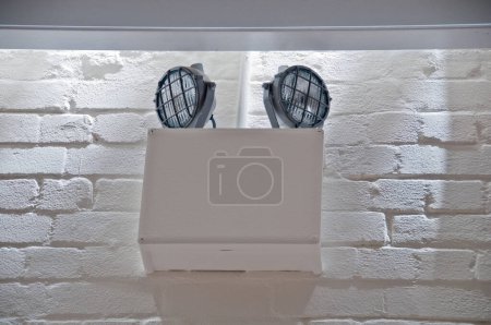 Photo for Emergency Blackout Light installed on white brick wall - Royalty Free Image