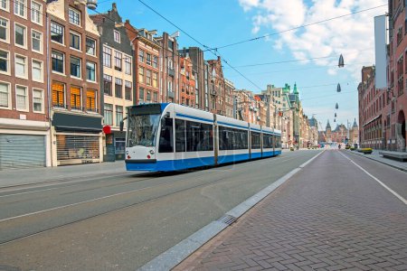 Photo for Tram driving at Damrak in Amsterdam the Netherlands - Royalty Free Image