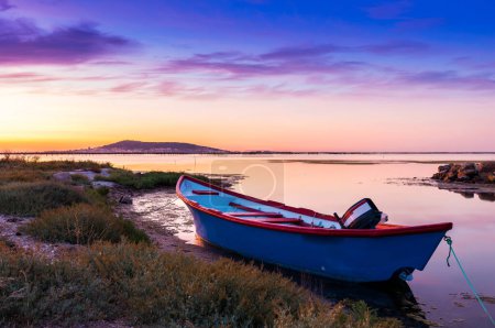 Photo for Rowboat on the Etang de Thau  Meze at dusk, in Hrault in Occitanie, France. - Royalty Free Image