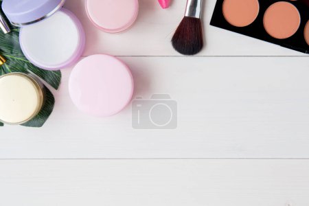 Photo for "cosmetic and skin care product and green leaves on white wood table" - Royalty Free Image