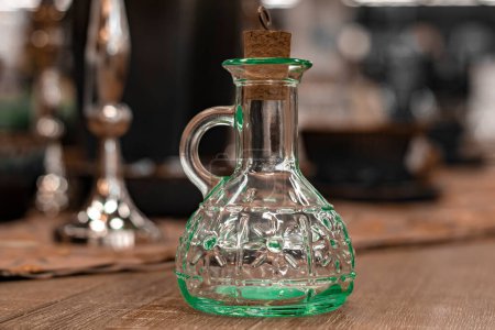 Photo for "Glass transparent carafe with cork on served table. Front view. New" - Royalty Free Image