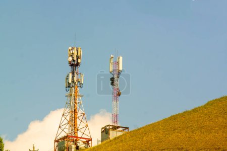 Photo for "two Mobile phone tower amid blue sky, communication" - Royalty Free Image
