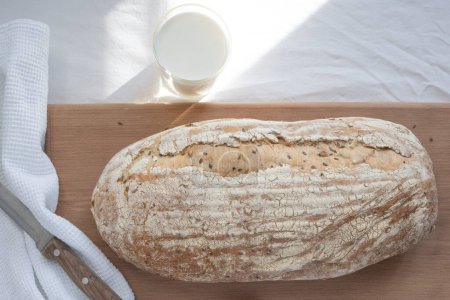 Photo for Wheat bread, a jug of milk and bread with sesame seeds - Royalty Free Image