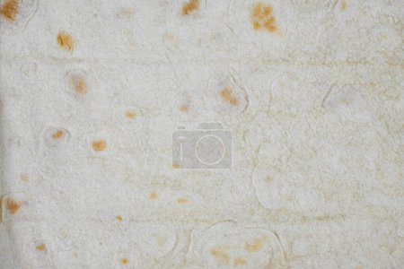 Photo for "Texture of thin traditional freshly baked homemade oriental bread. Close-up Armenian pita bread - lavash as a textured bread background." - Royalty Free Image