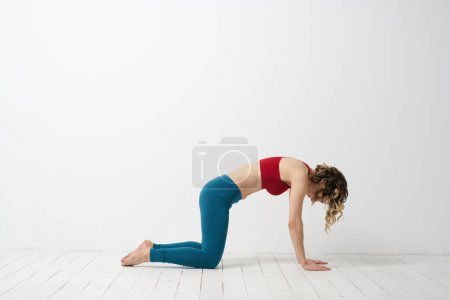 Photo for Woman in leggings is engaged in gymnastics in a light room slim figure fitness sport - Royalty Free Image