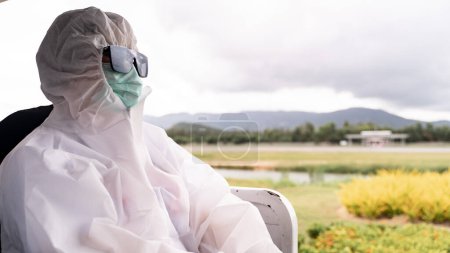 Photo for Person wearing protective suit , PPE with mask - Royalty Free Image