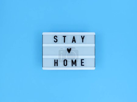 Photo for Light box with Stay home quote on a blue background. - Royalty Free Image