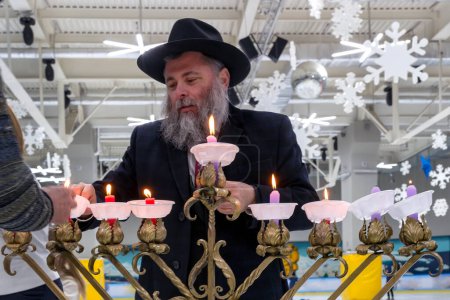 Photo for "02.09.2019 Kiev, Ukraine. chief rabbi of the city Kiev lights candles Hanukkah" - Royalty Free Image