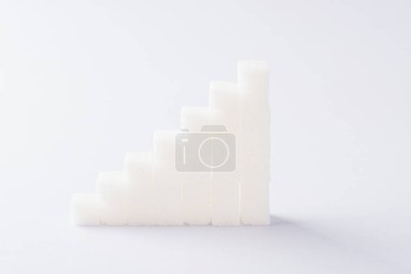 Foto de Ascending stacks of sugar cubes graph chart - Imagen libre de derechos