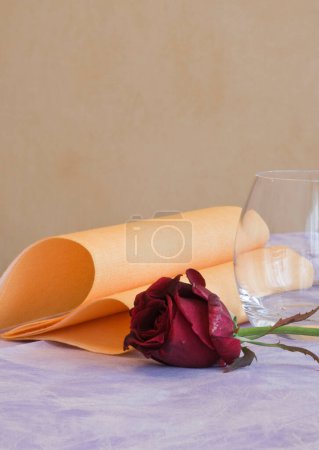Photo for Red wine glass on a wooden background with a bouquet of roses. - Royalty Free Image