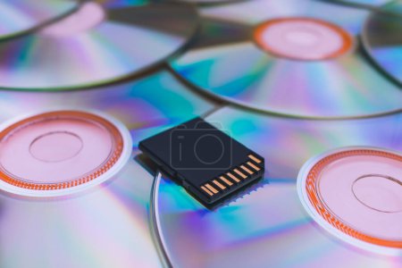 Photo for Modern storage of information on a flash drive compared to old disks. A modern flash drive lies on old CDs close-up - Royalty Free Image