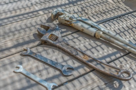 Photo for Set of wrenches and adjustable wrenches on a wooden floor - Royalty Free Image