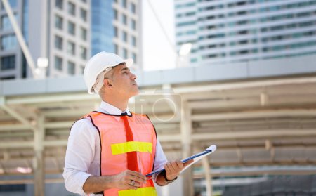 Foto de Engineering civil, Construction engineers discussion with architects at construction site or building site of high-rise building with Surveying for making contour plans - Imagen libre de derechos