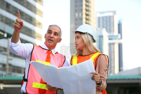 Photo for The engineer and business people hand high five against building. The concept of engineering, construction, city life and future - Royalty Free Image