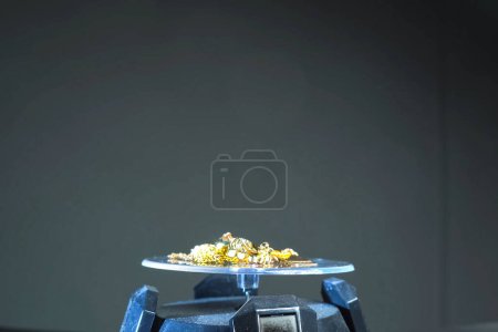 Photo for Golden scrap of old gold jewelry on electronic scales. - Royalty Free Image