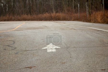 Photo for An arrow on the ground leading forward, concept of the right way forward - Royalty Free Image