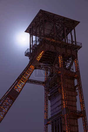 Photo for Old coalmine top of tower moon in back in Belgium Genk Winterslag Night picture - Royalty Free Image