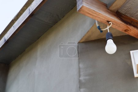Photo for "A white light bulb hangs on the porch" - Royalty Free Image