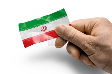 Foto de "Mano sosteniendo una tarjeta con una bandera nacional el Irán" - Imagen libre de derechos