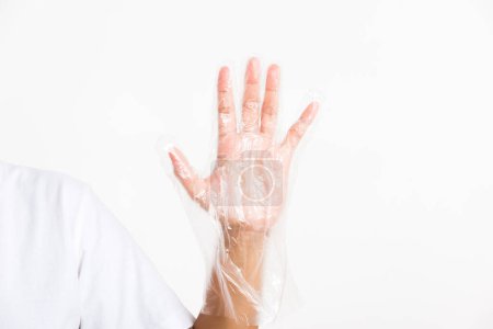 Foto de La mano de la mujer que usa un solo uso protege el guante plástico transparente desechable - Imagen libre de derechos