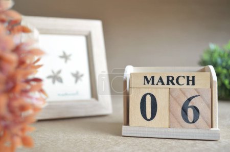 Photo for Wooden calendar with month of march and picture frame - Royalty Free Image