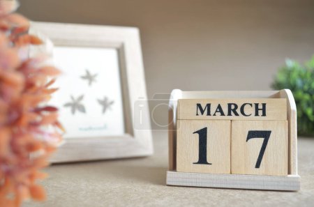 Photo for Wooden calendar with month of march and picture frame - Royalty Free Image