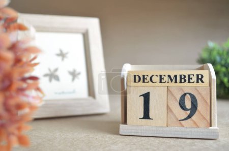 Photo for Wooden calendar with month of December and picture frame - Royalty Free Image