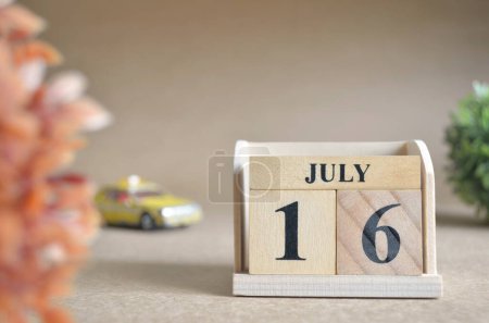 Photo for Wooden calendar with month of July, planning concept - Royalty Free Image
