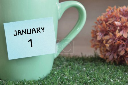 Téléchargez les photos : "gros plan de la tasse, note collante avec inscription 1er janvier." - en image libre de droit