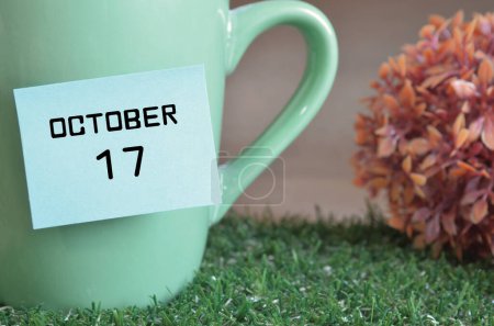 Photo for Mint colored cup with paper stick and october month date - Royalty Free Image