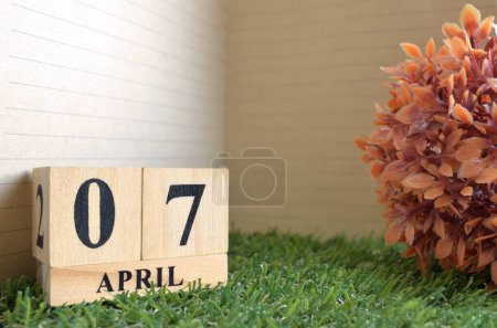 Photo for Wooden calendar with month of April with green grass - Royalty Free Image