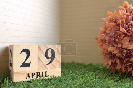 Photo for Wooden calendar with month of April with green grass - Royalty Free Image