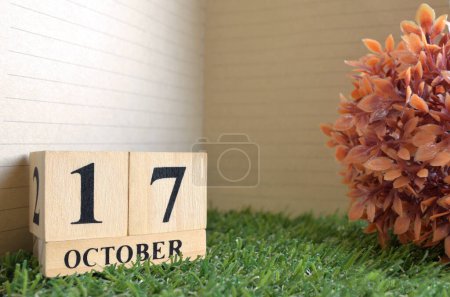 Photo for Wooden calendar on green grass and date October, 17 - Royalty Free Image