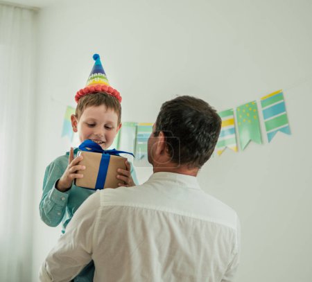 Photo for Five year old boy in his birthday hold gift box - Royalty Free Image