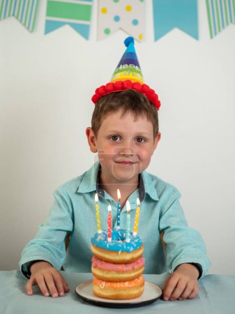 Photo for Happy boy and birthday donuts cake with candles - Royalty Free Image