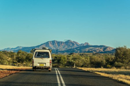 Photo for Scenic panorama of a car driving on the namatjira drive to MacDonnell National Park in NT central outback Australia - Royalty Free Image
