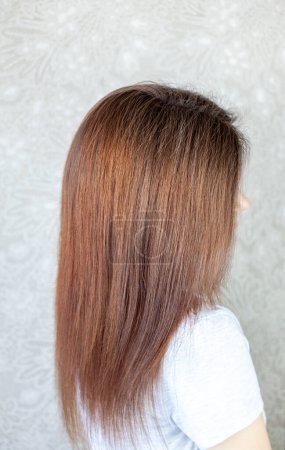 Photo for A girl with long, straight and beautiful brown hair. Hair care at home - Royalty Free Image