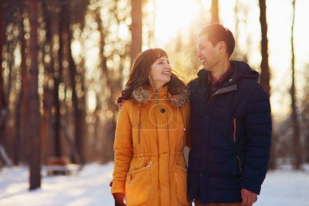 Téléchargez les photos : Portrait hivernal chaleureux de jeunes couples souriants interracial en promenade dans la forêt - en image libre de droit