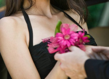 Photo for Teenage Girl Receiving Corsage from Date - Royalty Free Image