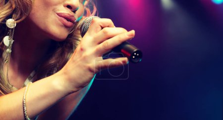 Téléchargez les photos : Plan recadré de femme chantant au microphone - en image libre de droit