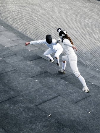 Photo for Two fencers fencing outside together - Royalty Free Image