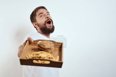 Photo for Man with a mug of beer fast food diet food alcohol fun light background - Royalty Free Image